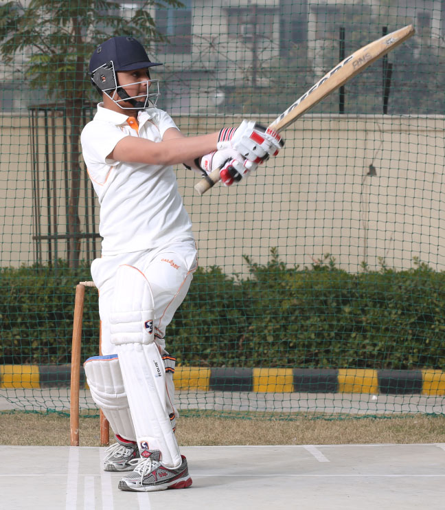 Students playing cricket